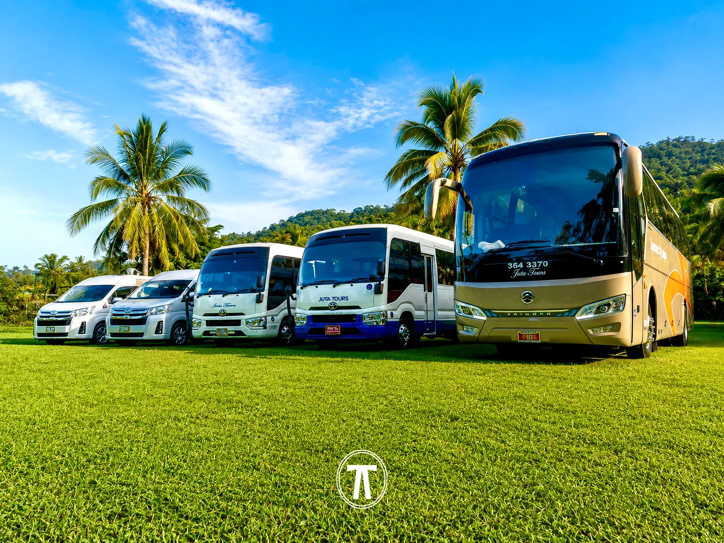 Line-up of Nakdar Transport's fleet — vans, a mini coach, and a full-size coach — parked together in Jamaica