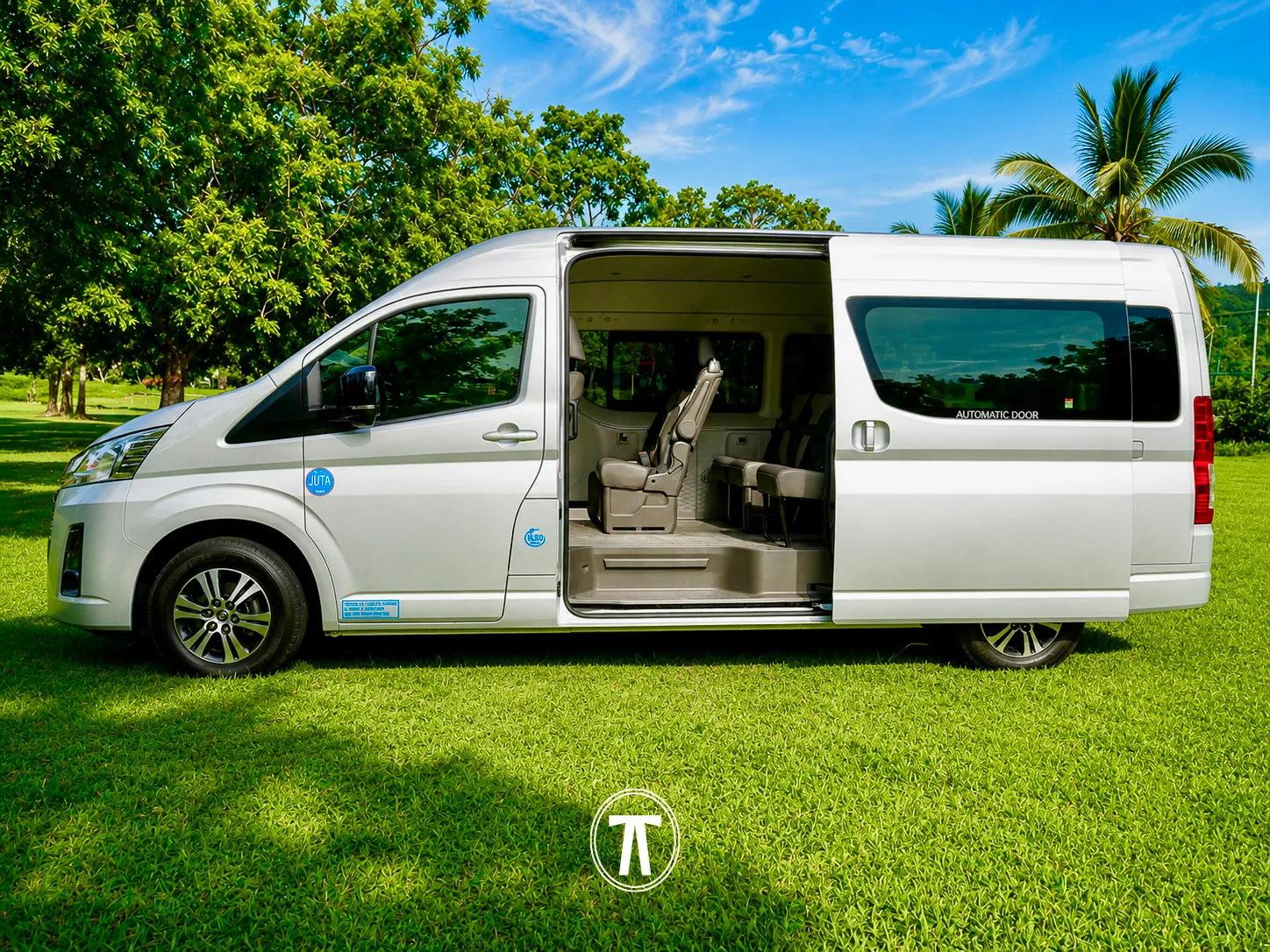 Silver passenger van with the side door open, showing the interior seating